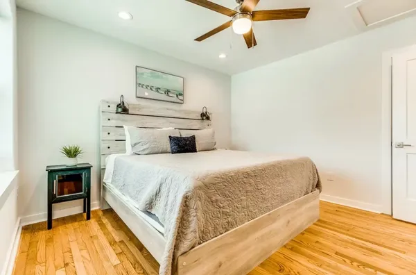 a bedroom with a bed and a chandelier