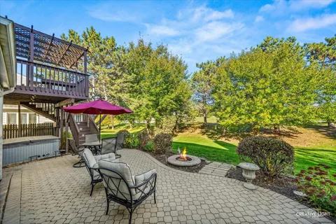 a view of a patio with a table and chairs under an umbrella