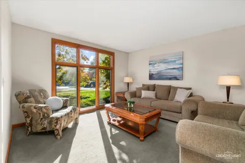 a living room with furniture and a large window with outer view