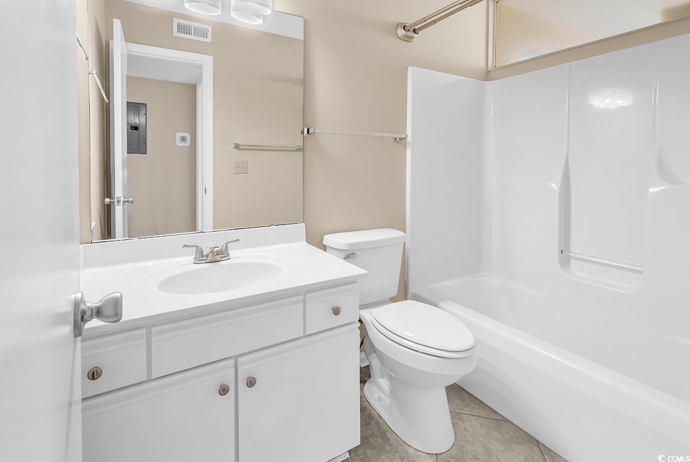8796 Chandler Drive, Unit F Surfside Beach, SC 29575 - Photo 15 of 21 Full bathroom with vanity, light tile patterned floors, shower / bathtub combination, and electric panel