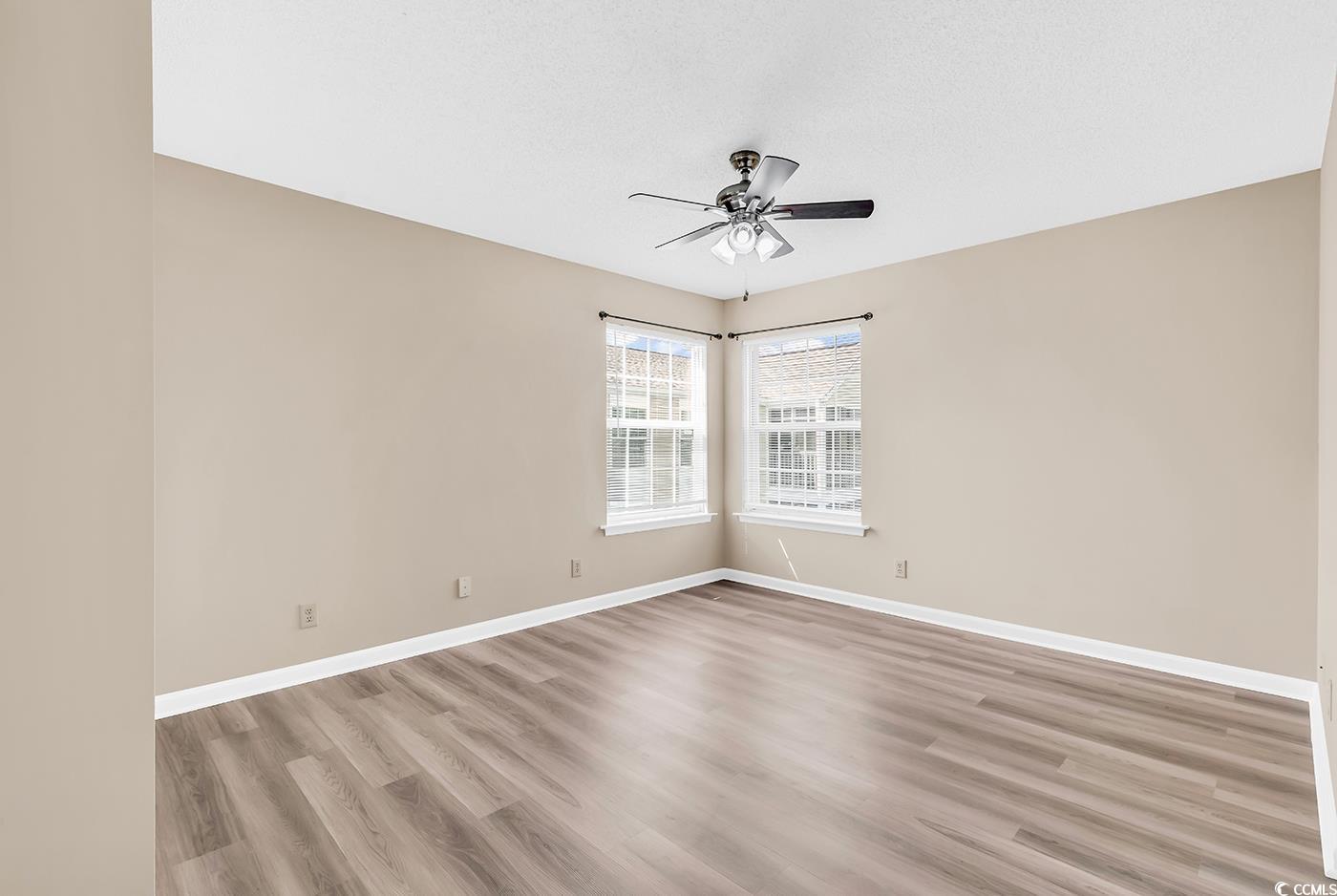 8796 Chandler Drive, Unit F Surfside Beach, SC 29575 - Photo 16 of 21 Empty room featuring light wood-type flooring and ceiling fan