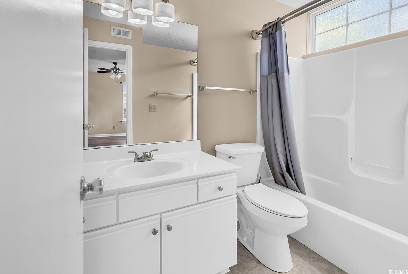 8796 Chandler Drive, Unit F Surfside Beach, SC 29575 - Photo 18 of 21 Bathroom featuring vanity, shower / tub combo, light tile patterned floors, and ceiling fan