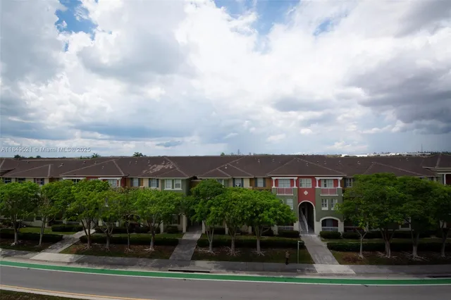 a view of a house with swimming pool and sitting area