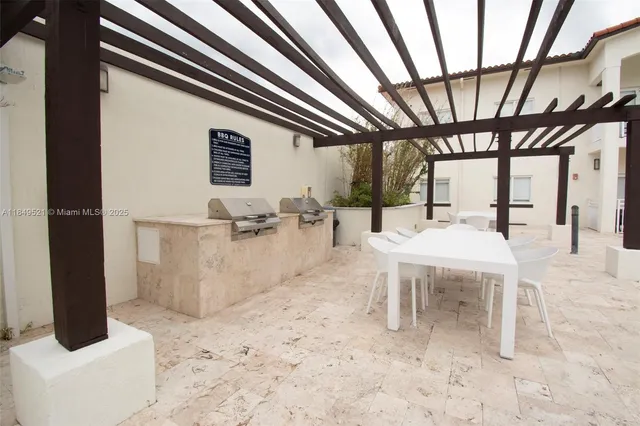 a room with gym equipment and wooden floor