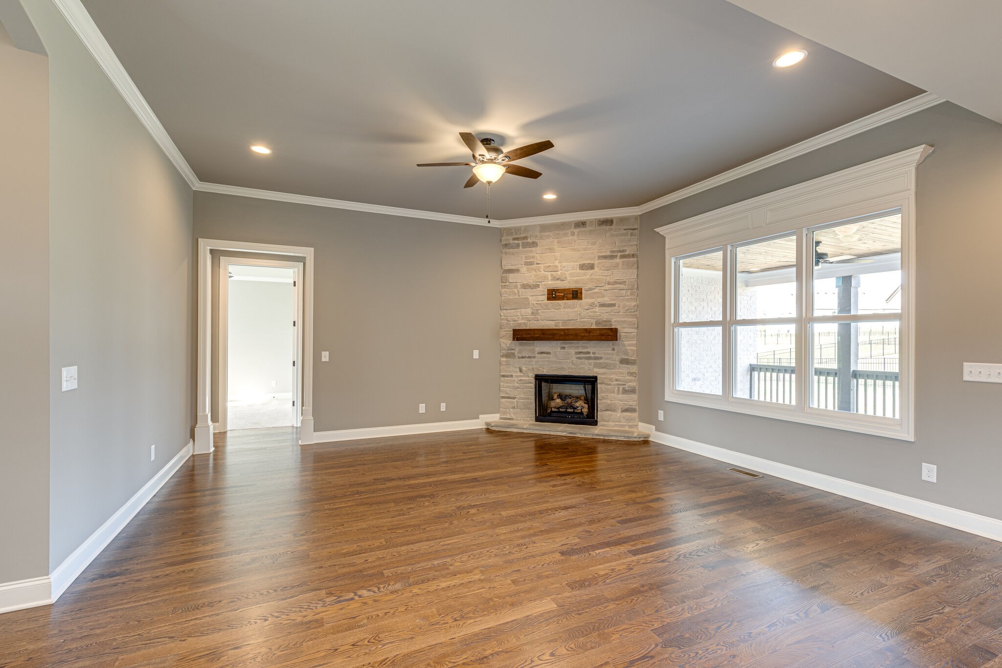 2040 Imagine Circle Spring Hill, TN 37174 - Photo 11 of 51 an empty room with windows fireplace and a kitchen view