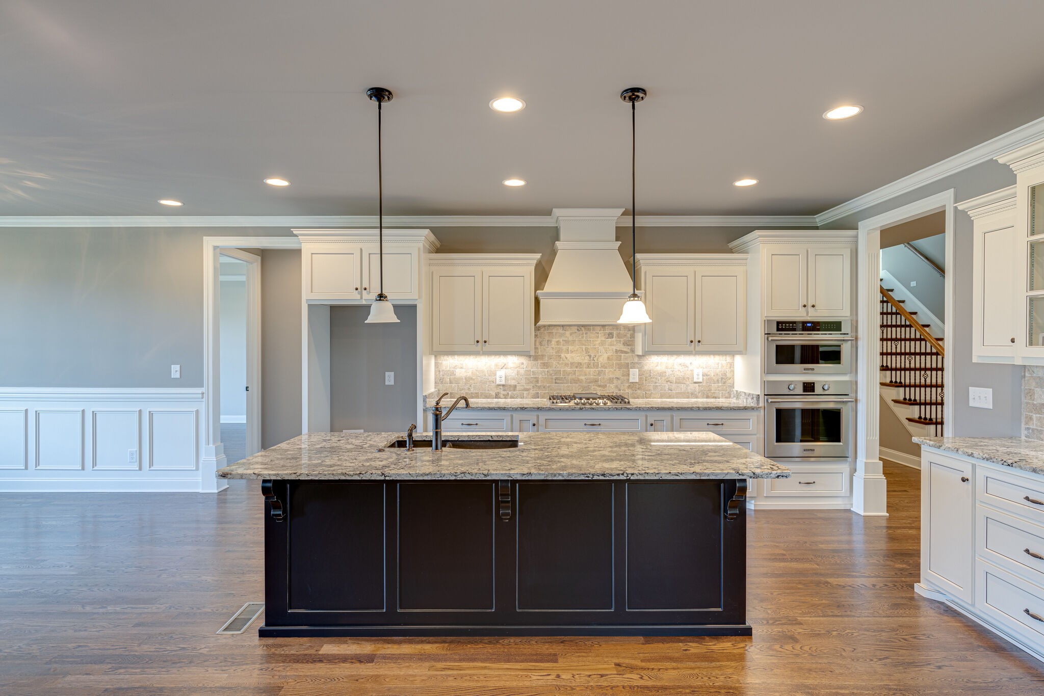2040 Imagine Circle Spring Hill, TN 37174 - Photo 14 of 51 a kitchen with kitchen island granite countertop wooden floors stainless steel appliances and cabinets