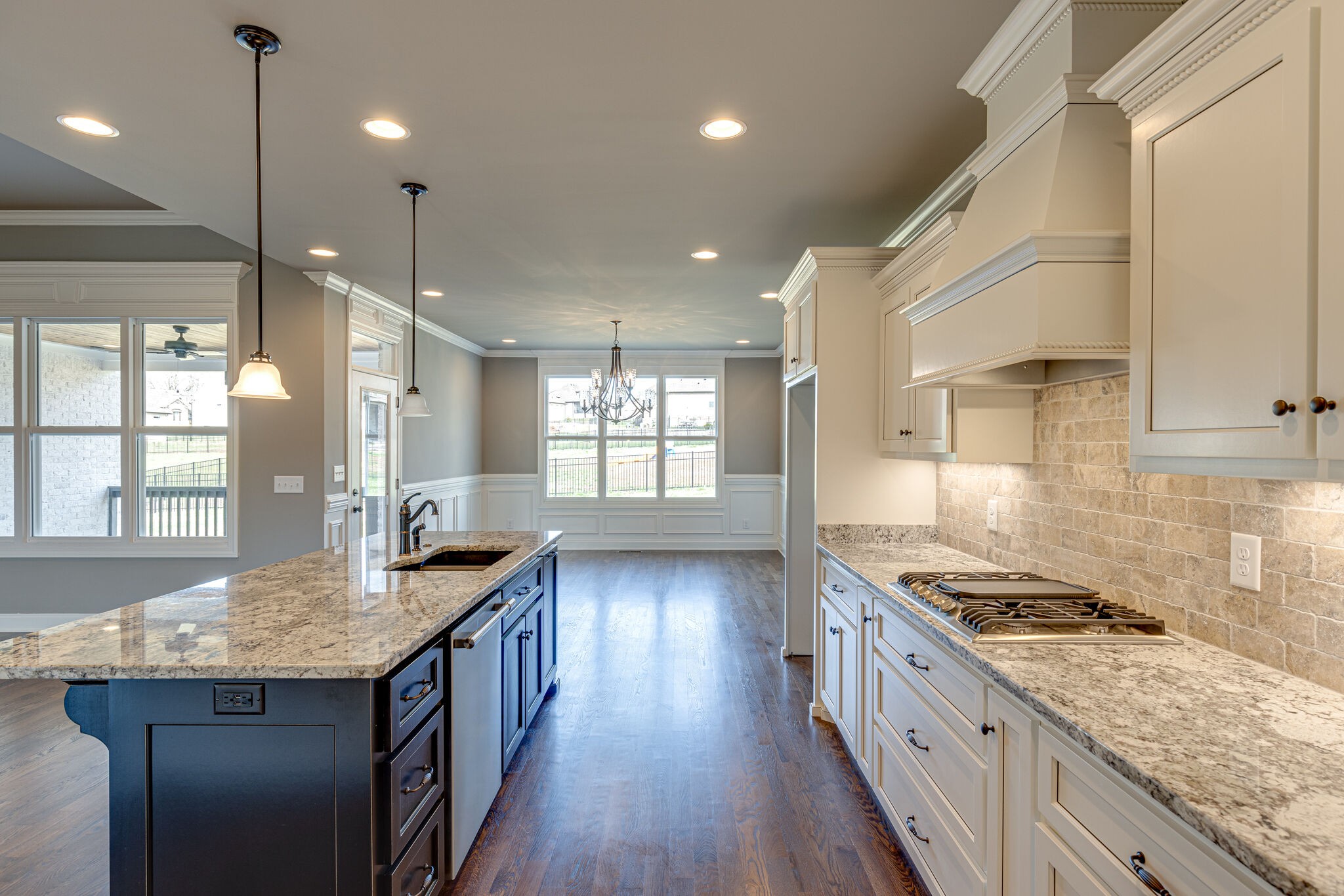 2040 Imagine Circle Spring Hill, TN 37174 - Photo 19 of 51 a kitchen with granite countertop a stove a sink a refrigerator wooden floor and cabinets