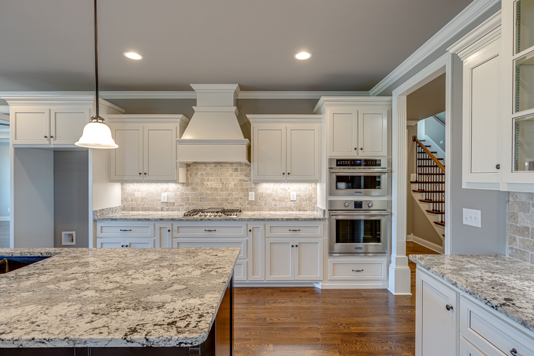 2040 Imagine Circle Spring Hill, TN 37174 - Photo 20 of 51 a kitchen with kitchen island granite countertop a stove a sink a oven and a refrigerator with wooden floor