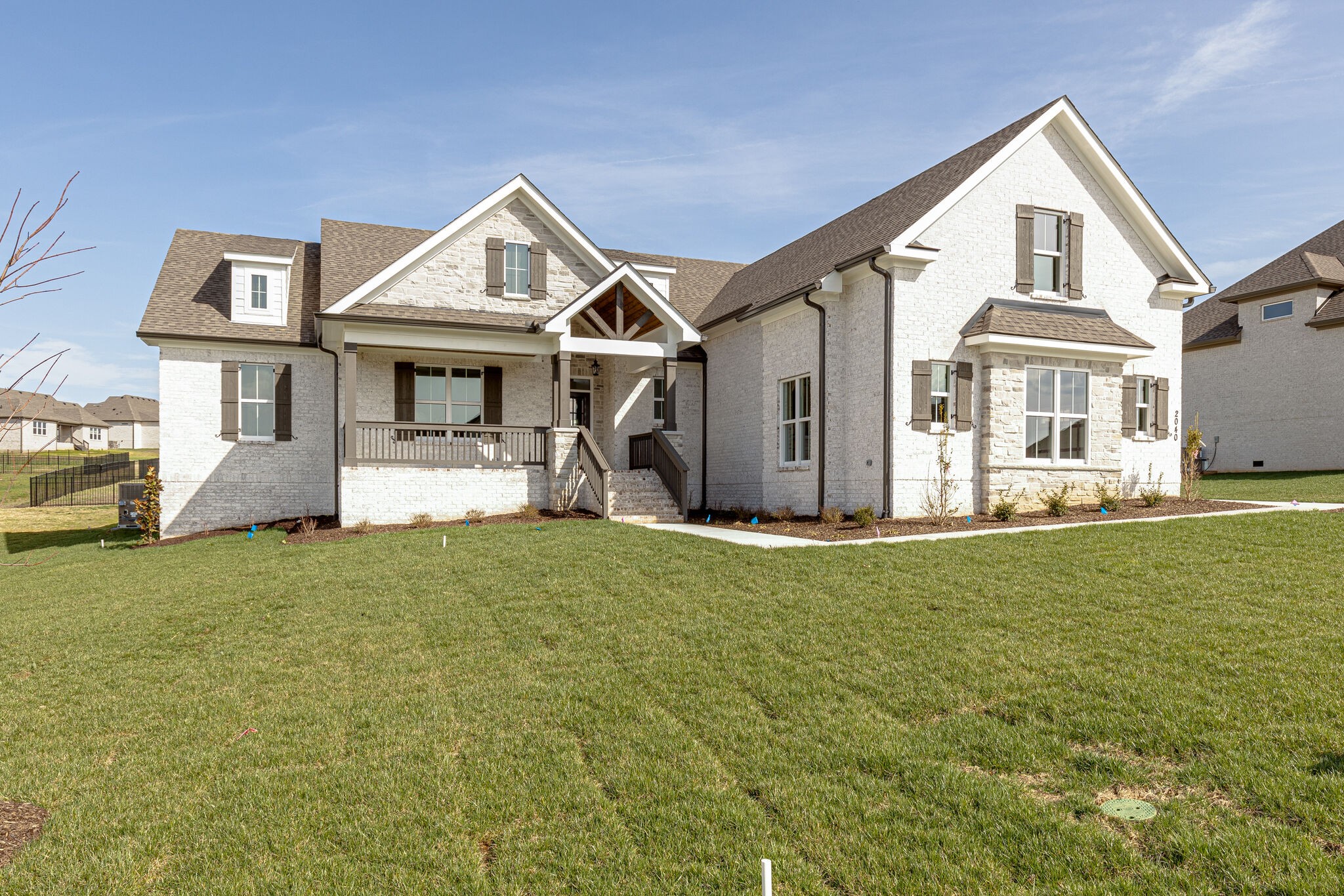2040 Imagine Circle Spring Hill, TN 37174 - Photo 2 of 51 a front view of a house with a garden and yard