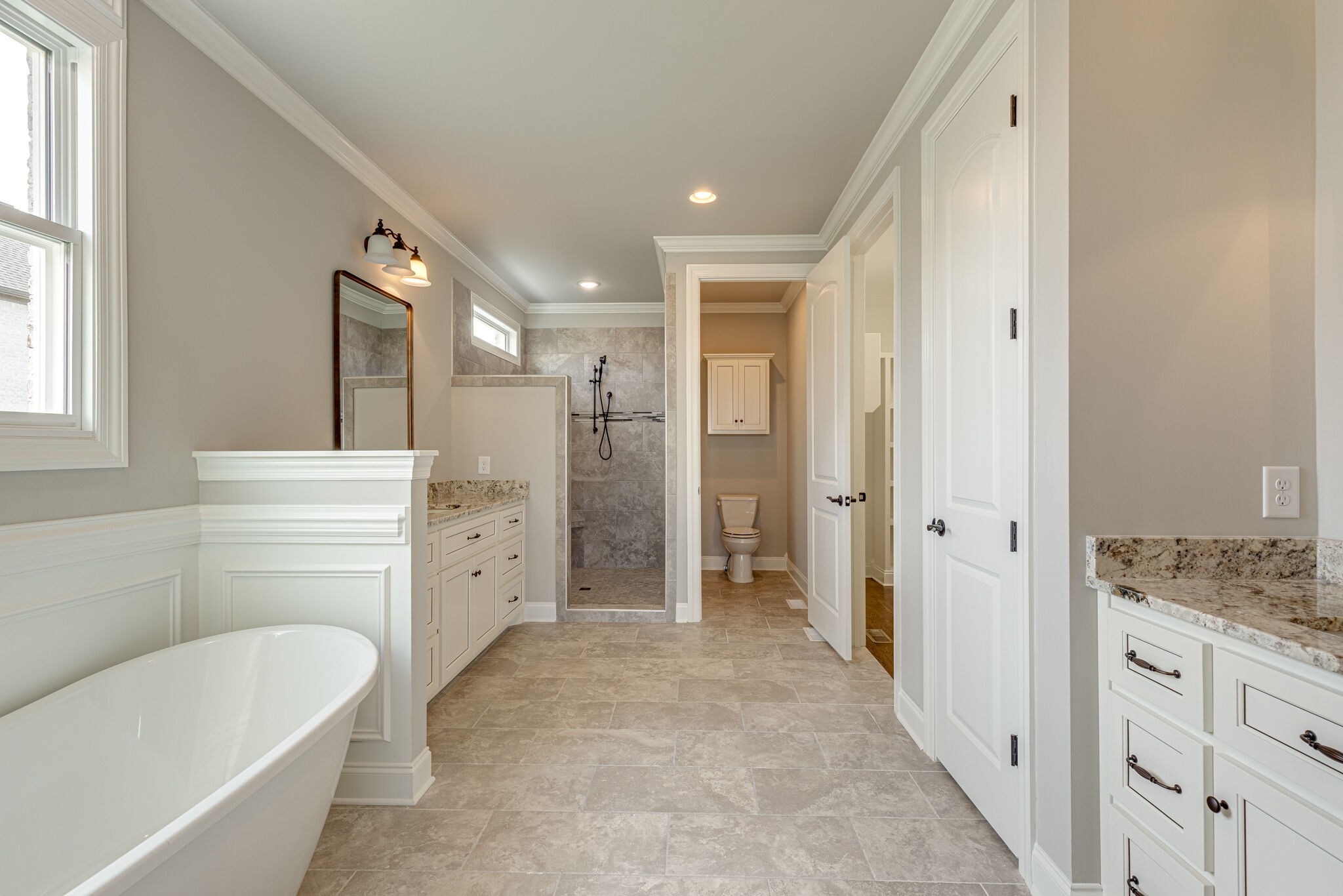 2040 Imagine Circle Spring Hill, TN 37174 - Photo 26 of 51 a bathroom with a granite countertop sink a large mirror and a bathtub