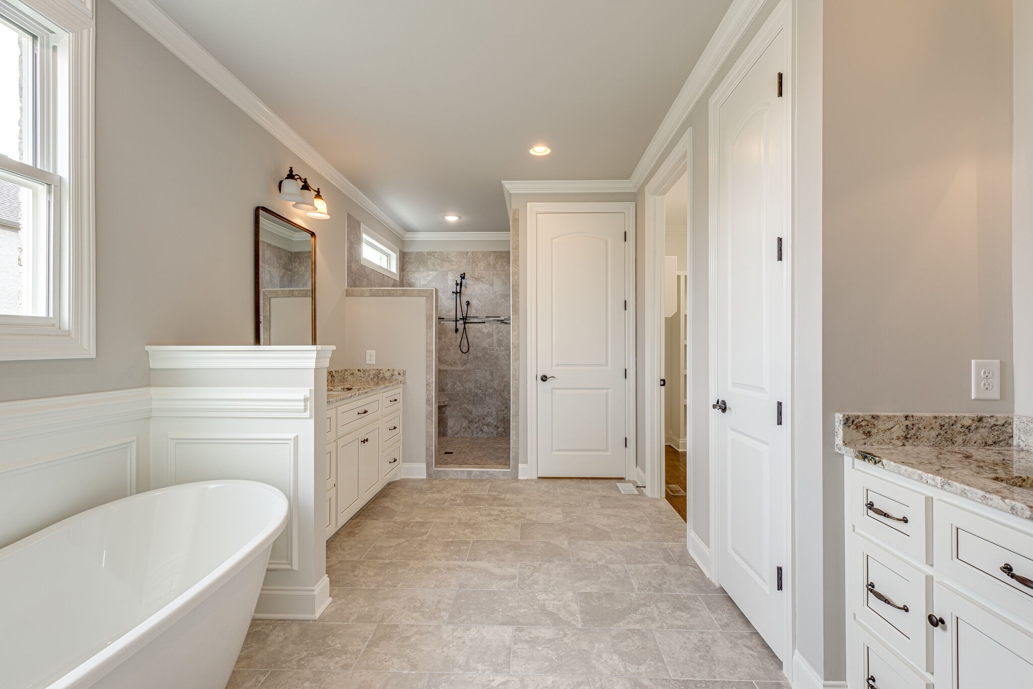 2040 Imagine Circle Spring Hill, TN 37174 - Photo 27 of 51 a bathroom with a granite countertop sink a large mirror and a bathtub