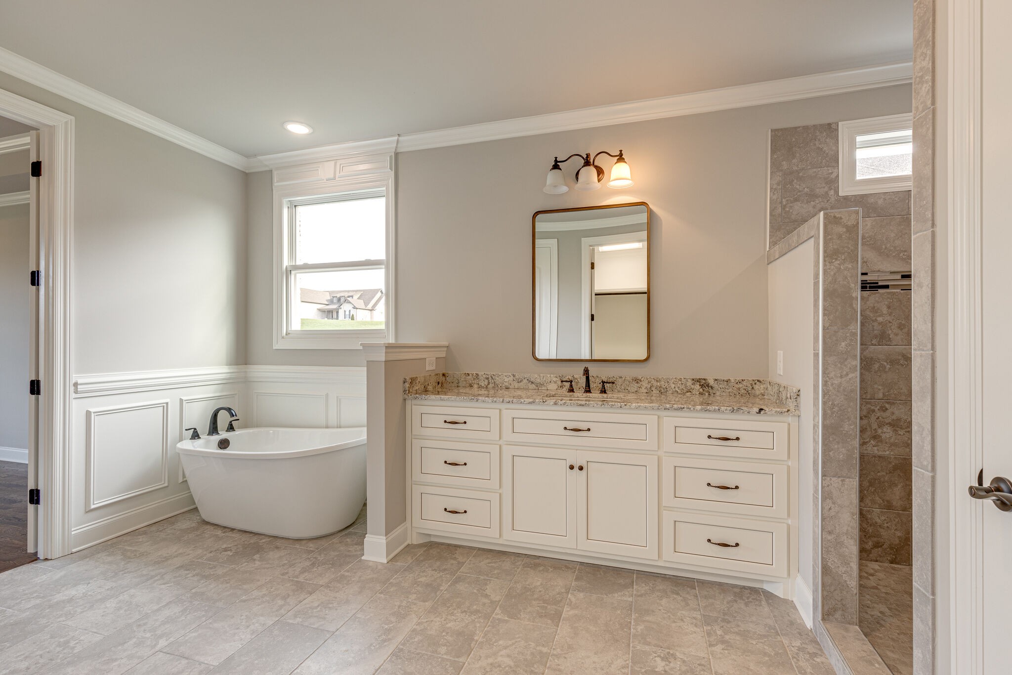 2040 Imagine Circle Spring Hill, TN 37174 - Photo 28 of 51 a spacious bathroom with a double vanity sink a mirror and a bathtub