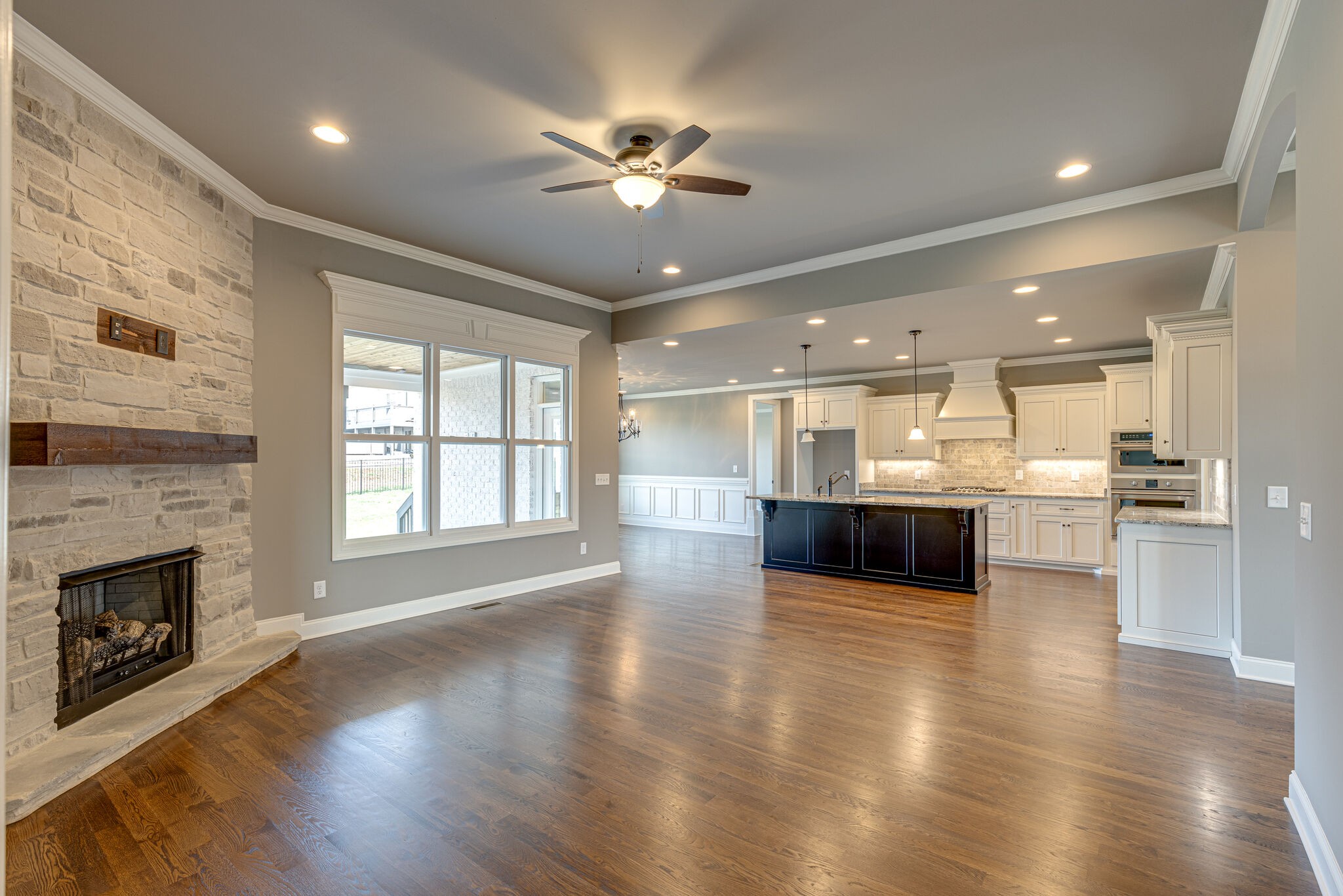 2040 Imagine Circle Spring Hill, TN 37174 - Photo 9 of 51 a view of an empty room and kitchen with a fireplace wooden floor