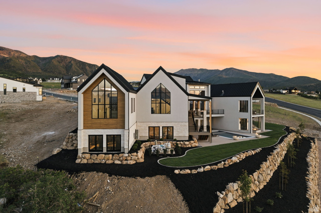 923 North Emery Lane Elk Ridge, UT 84651 - Photo 95 of 101 Contemporary architectural style featuring expansive windows, a sleek black roof, and exterior finishes combining light-toned siding, wood paneling, and stone accents