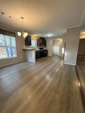 a kitchen with kitchen island a counter top space a sink and appliances