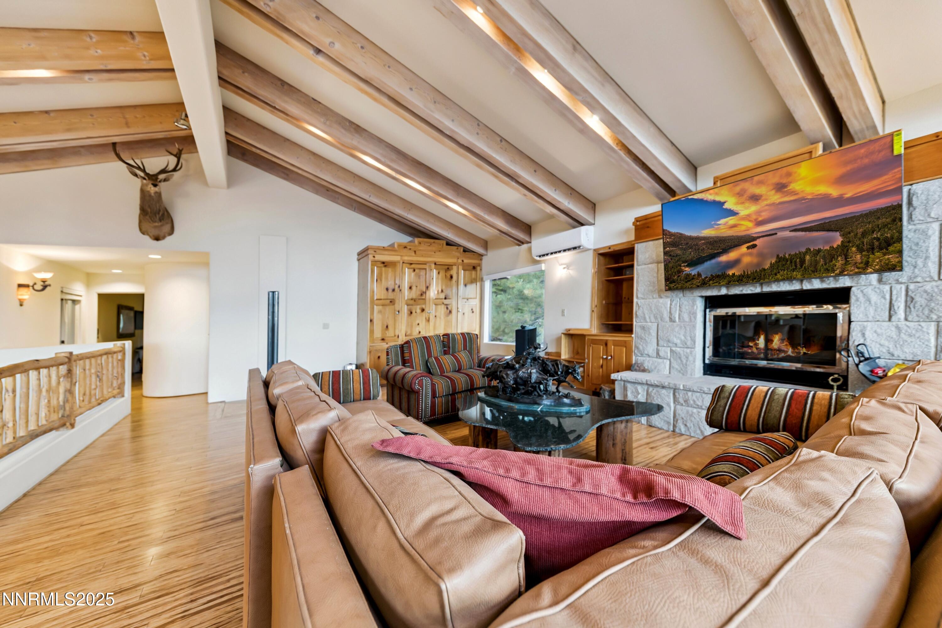 130 Granite Crest Drive Stateline, NV 89449 - Photo 16 of 85 a living room with furniture a fireplace and a flat screen tv