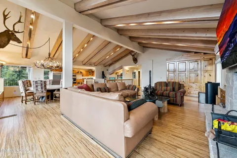 a room with stainless steel appliances kitchen island granite countertop a refrigerator and a sink