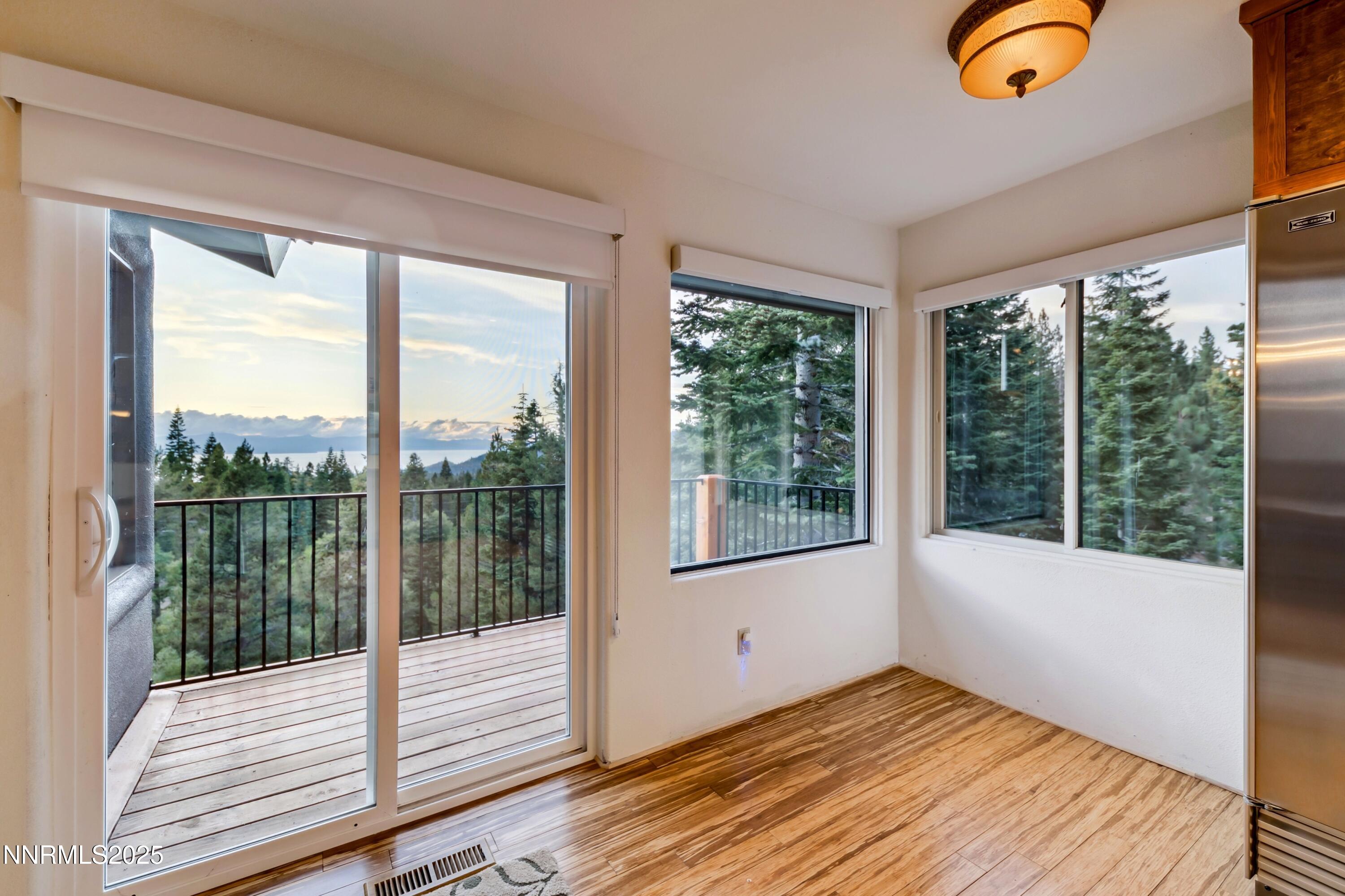 130 Granite Crest Drive Stateline, NV 89449 - Photo 23 of 85 a view of an empty room with wooden floor and windows