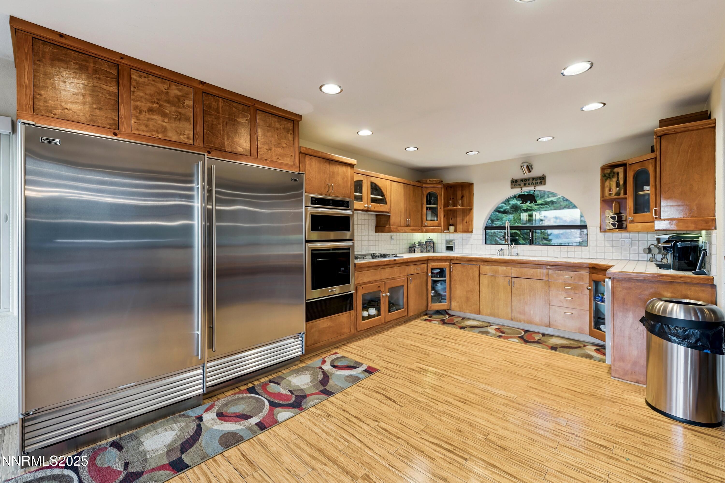 130 Granite Crest Drive Stateline, NV 89449 - Photo 29 of 85 a kitchen with stainless steel appliances granite countertop a refrigerator and a stove top oven