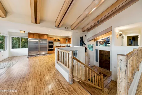 a large kitchen with stainless steel appliances a large counter top a stove and a sink