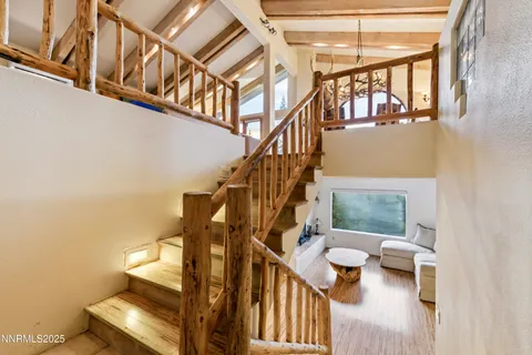 a dining room with furniture a chandelier and window