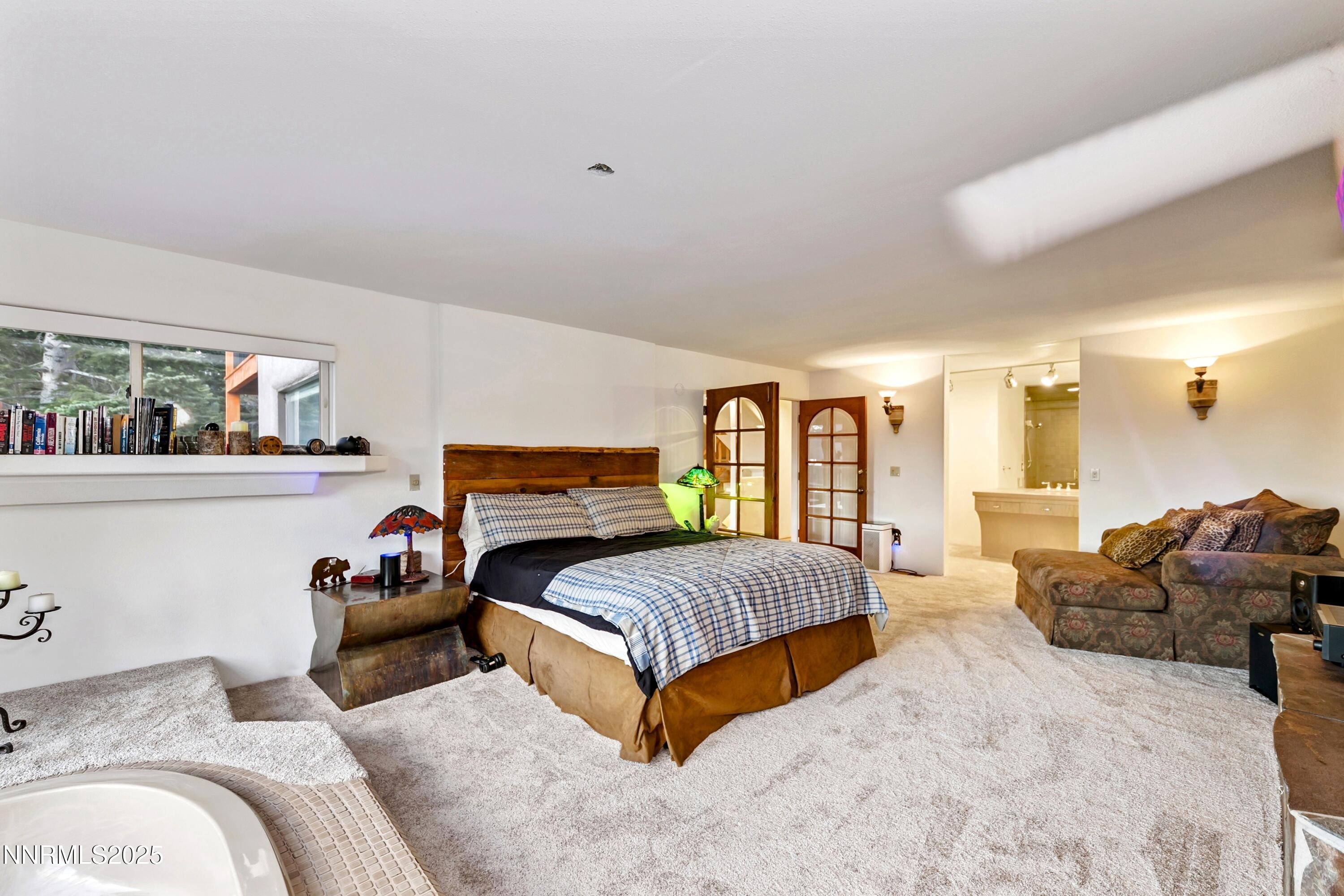 130 Granite Crest Drive Stateline, NV 89449 - Photo 47 of 85 a spacious bedroom with a bed and window