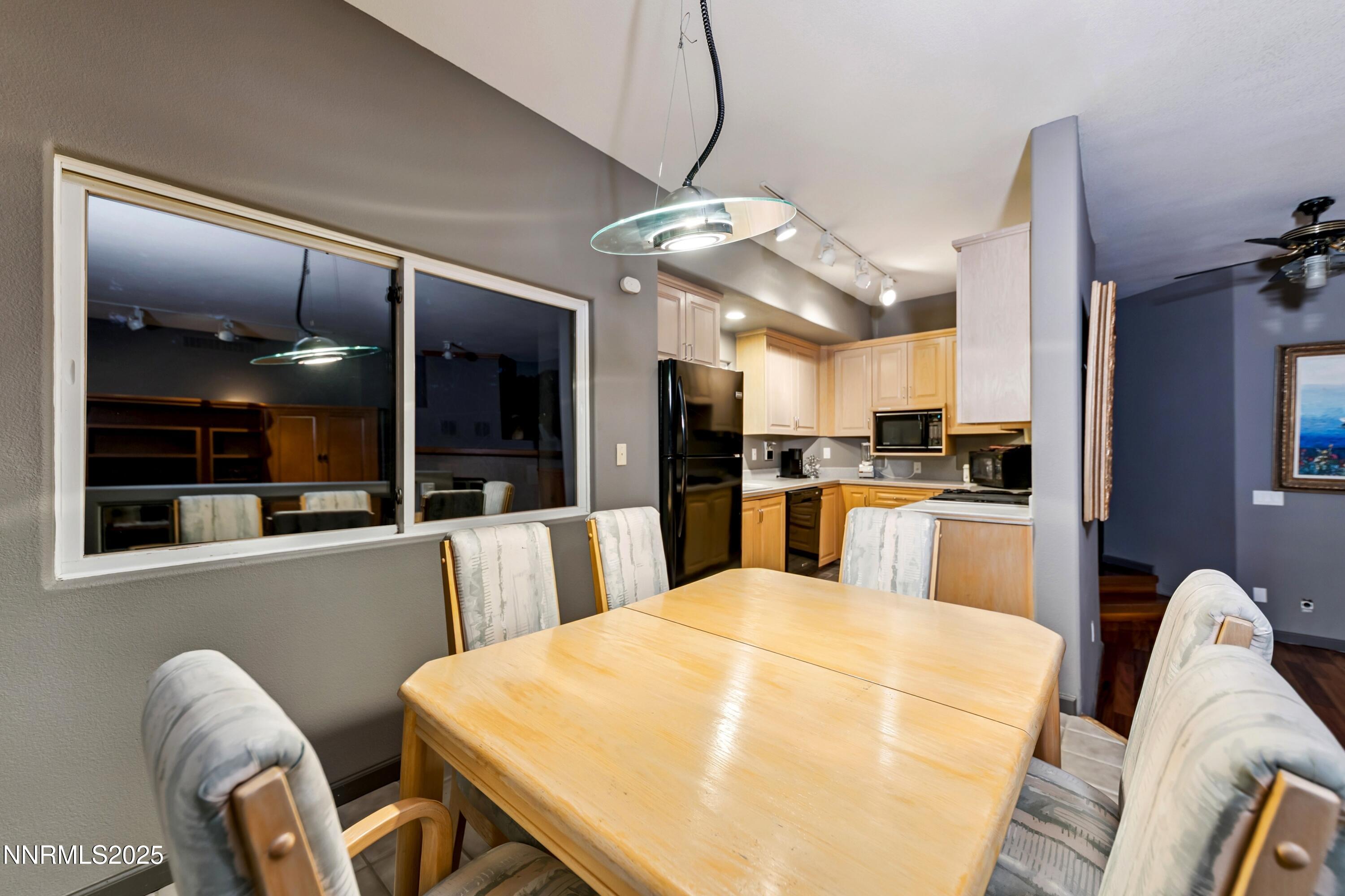 130 Granite Crest Drive Stateline, NV 89449 - Photo 64 of 85 a kitchen with stainless steel appliances kitchen island granite countertop a refrigerator a stove top oven a dining table and chairs with wooden floor