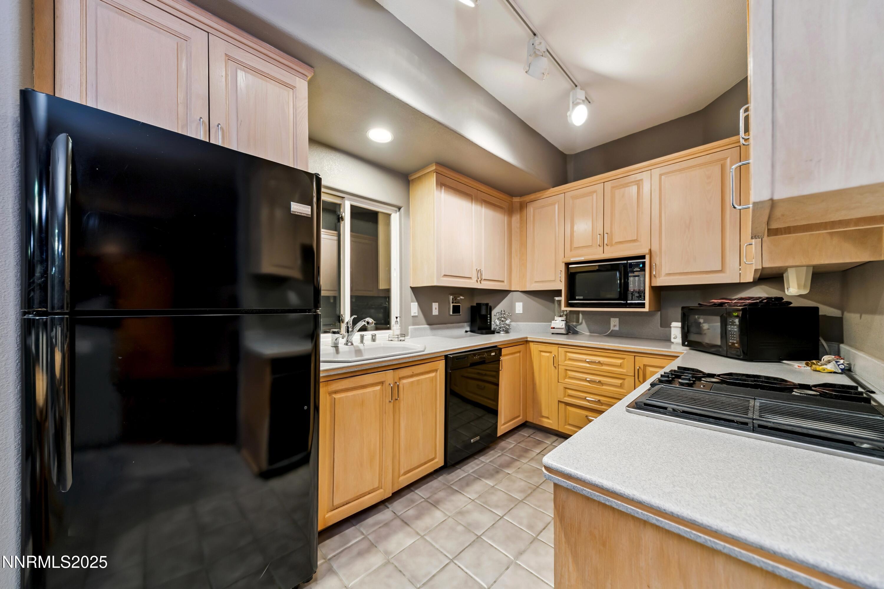 130 Granite Crest Drive Stateline, NV 89449 - Photo 65 of 85 a kitchen with stainless steel appliances granite countertop a refrigerator a stove top oven a sink and dishwasher