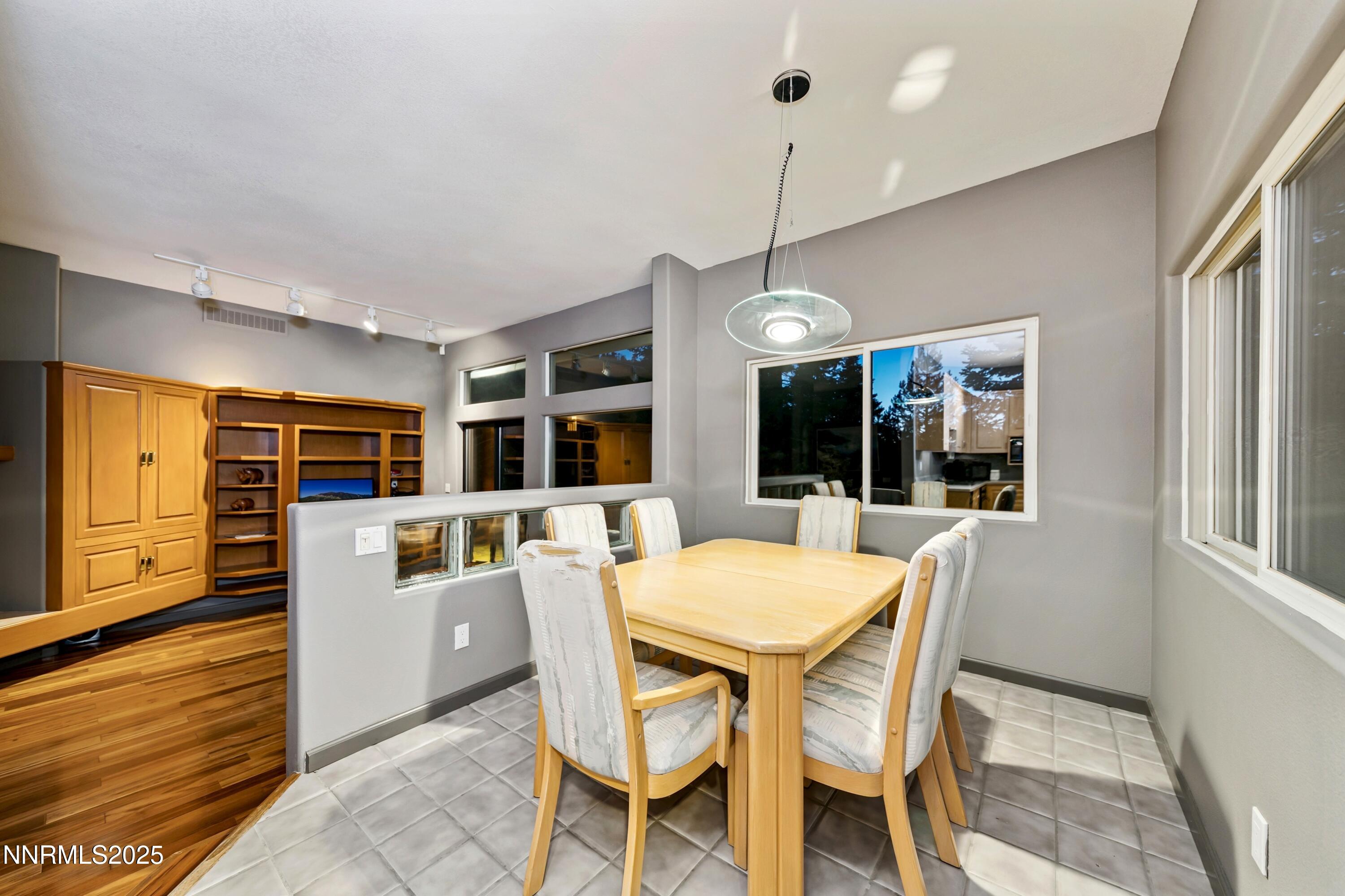 130 Granite Crest Drive Stateline, NV 89449 - Photo 66 of 85 a dining room with furniture a chandelier and window