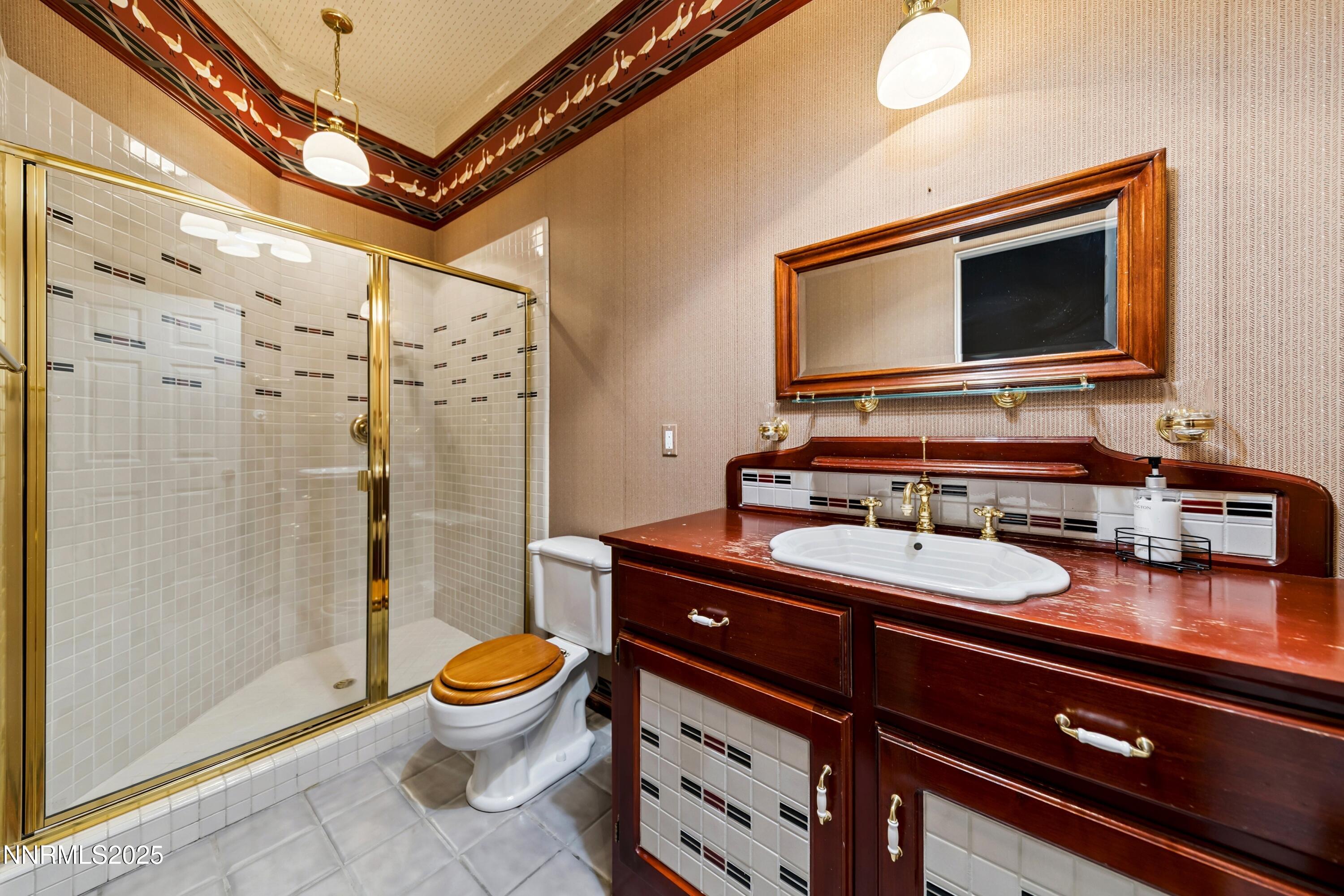 130 Granite Crest Drive Stateline, NV 89449 - Photo 75 of 85 a bathroom with a granite countertop sink toilet a mirror and shower