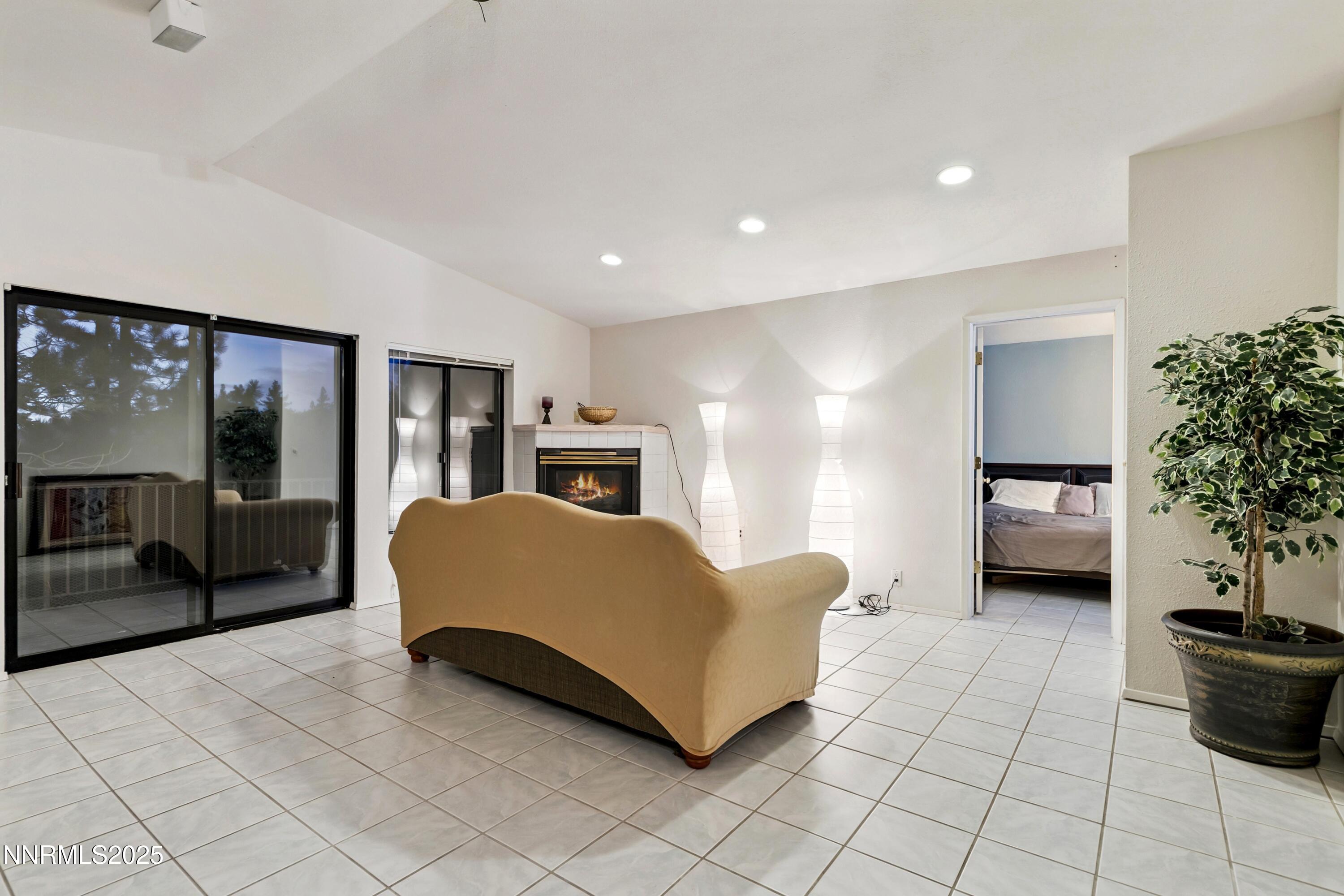 130 Granite Crest Drive Stateline, NV 89449 - Photo 82 of 85 a spacious bedroom with a bed and a potted plant