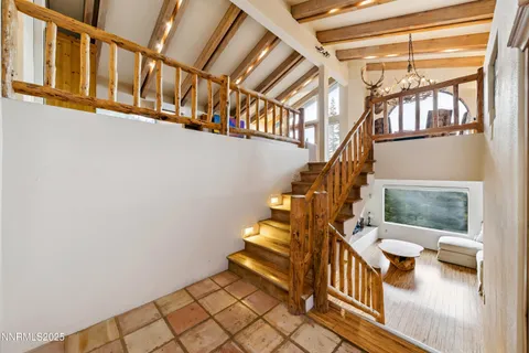 a living room with furniture a fireplace and a large window