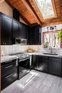 a kitchen with stainless steel appliances granite countertop a stove and a sink
