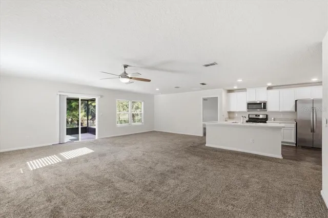 an empty room with a empty space and windows