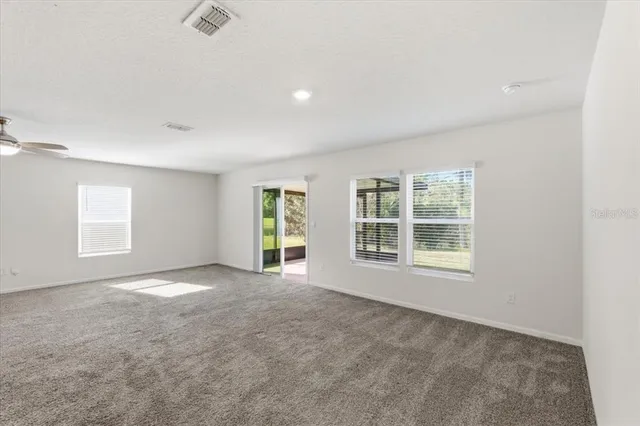 a view of a big room with windows and cabinet