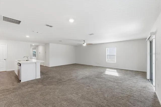 a kitchen with stainless steel appliances granite countertop a refrigerator sink and stove