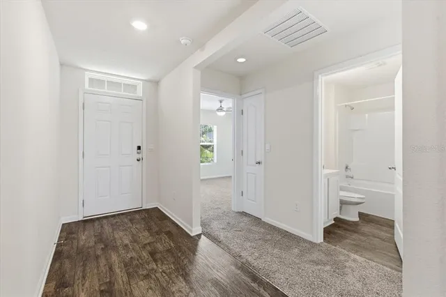 a view of a house with a yard and a pond