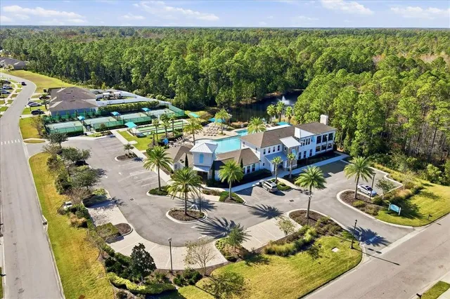 an aerial view of residential houses with outdoor space and street view