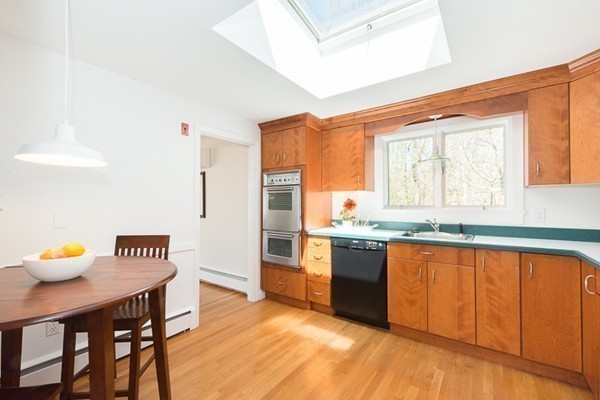 14 Russell Road Lexington, MA 02420 - Photo 6 of 20 a kitchen with stainless steel appliances granite countertop a sink cabinets and wooden floor