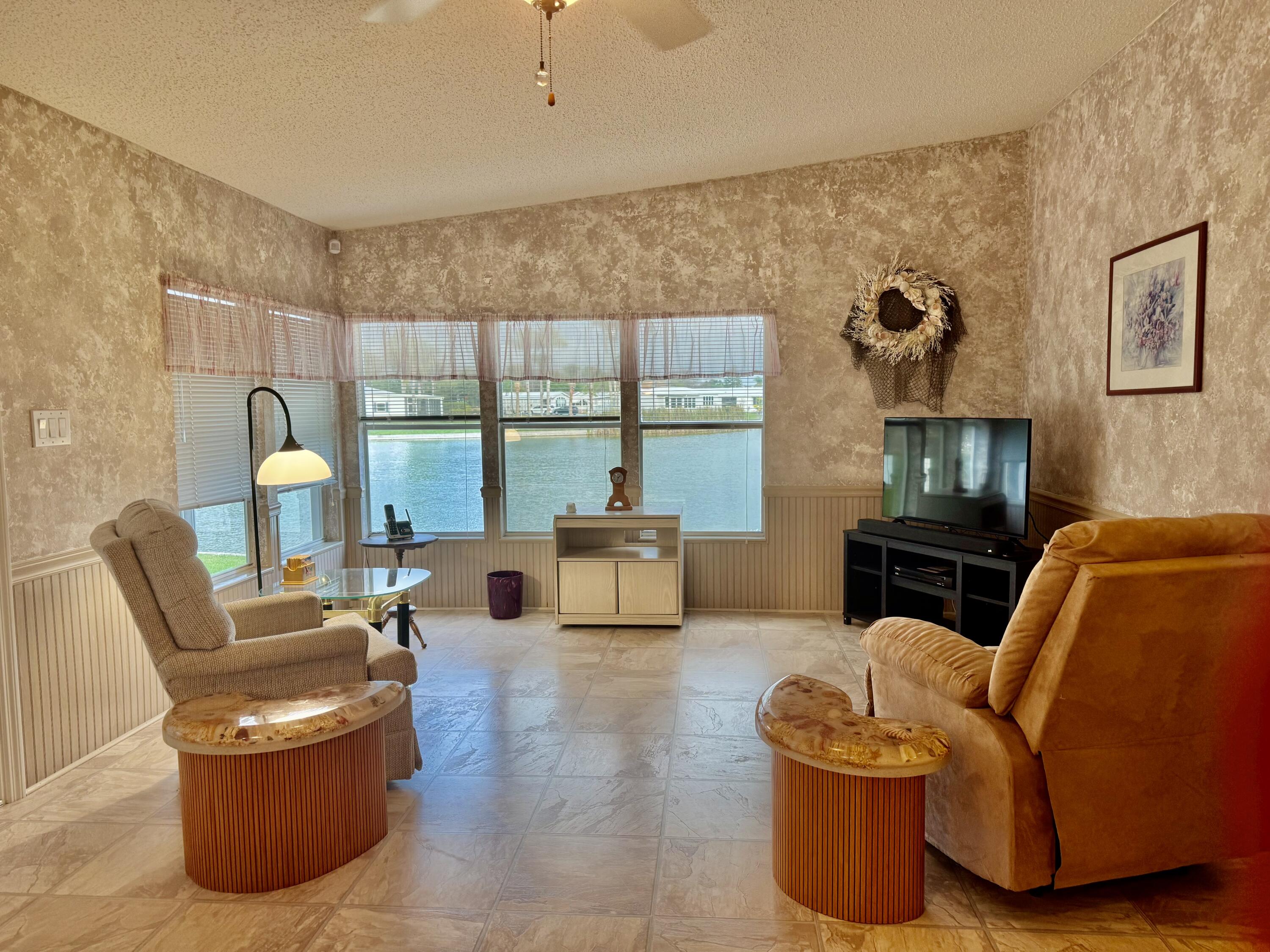 1704 Southwest 35th Circle Okeechobee, FL 34974 - Photo 12 of 44 a living room with furniture and a fireplace