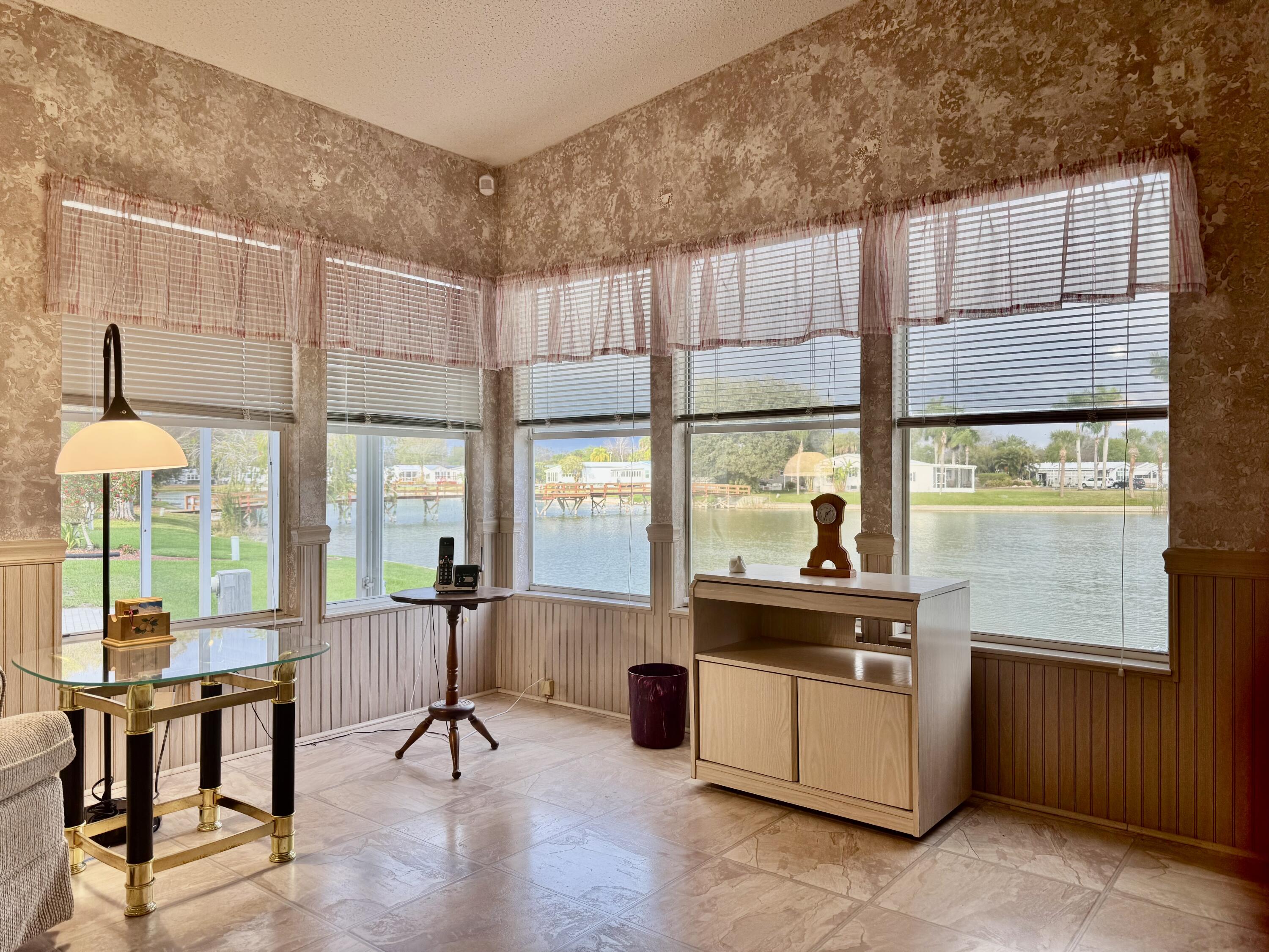 1704 Southwest 35th Circle Okeechobee, FL 34974 - Photo 14 of 44 a living room with furniture and a large window