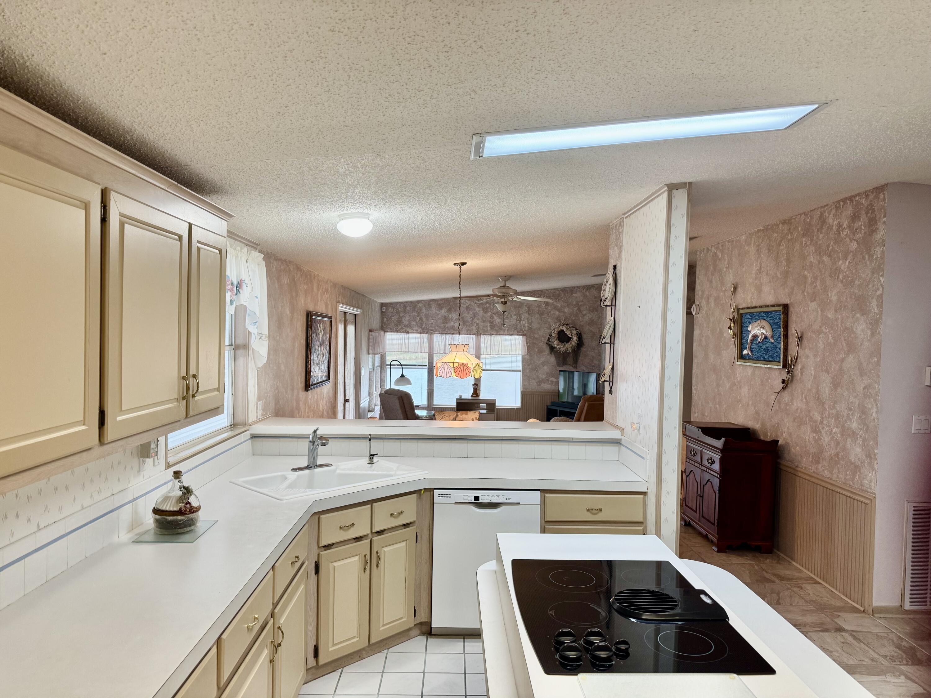 1704 Southwest 35th Circle Okeechobee, FL 34974 - Photo 16 of 44 a kitchen with granite countertop a sink stove and cabinets