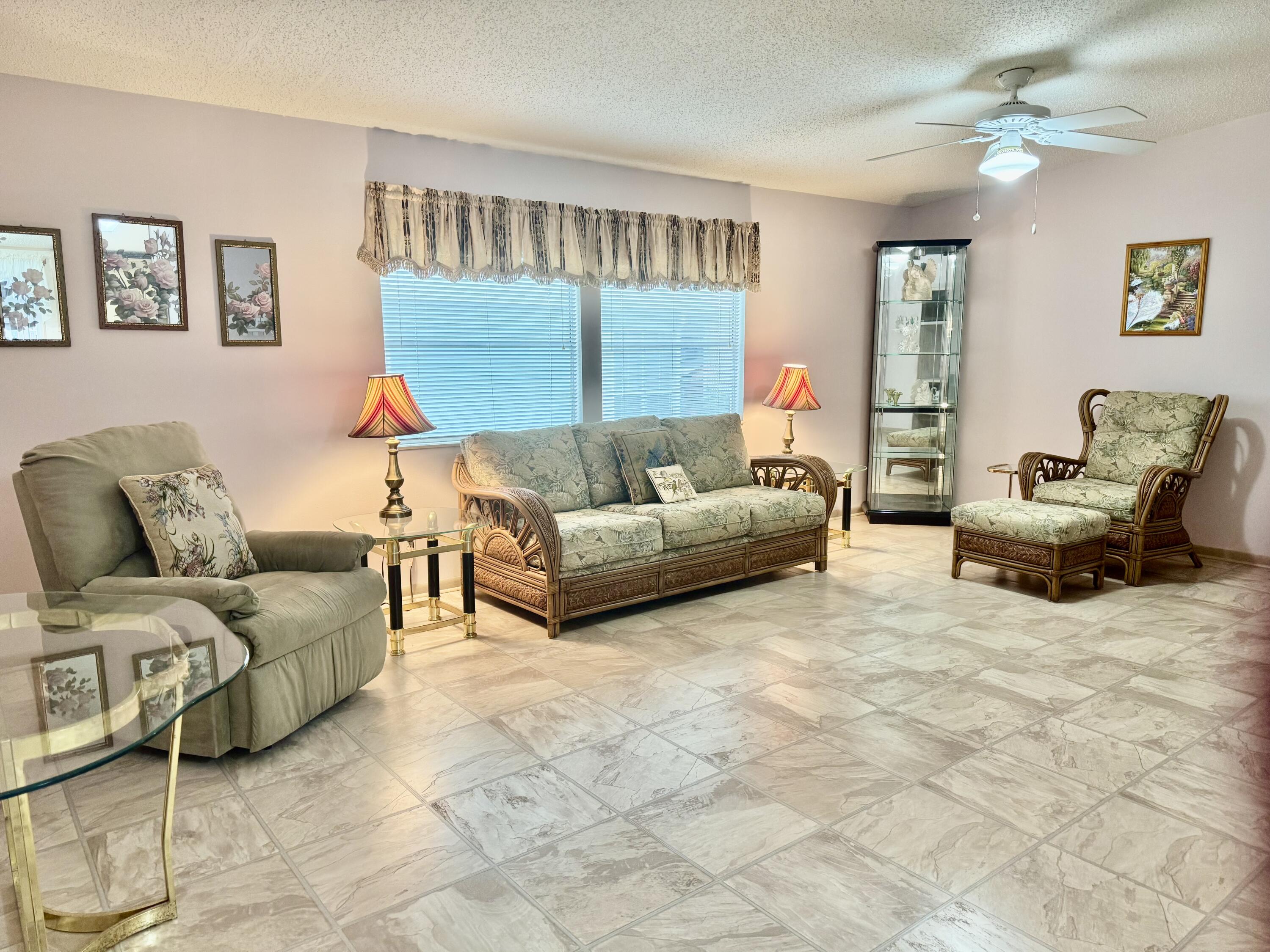 1704 Southwest 35th Circle Okeechobee, FL 34974 - Photo 3 of 44 a living room with furniture and a flat screen tv