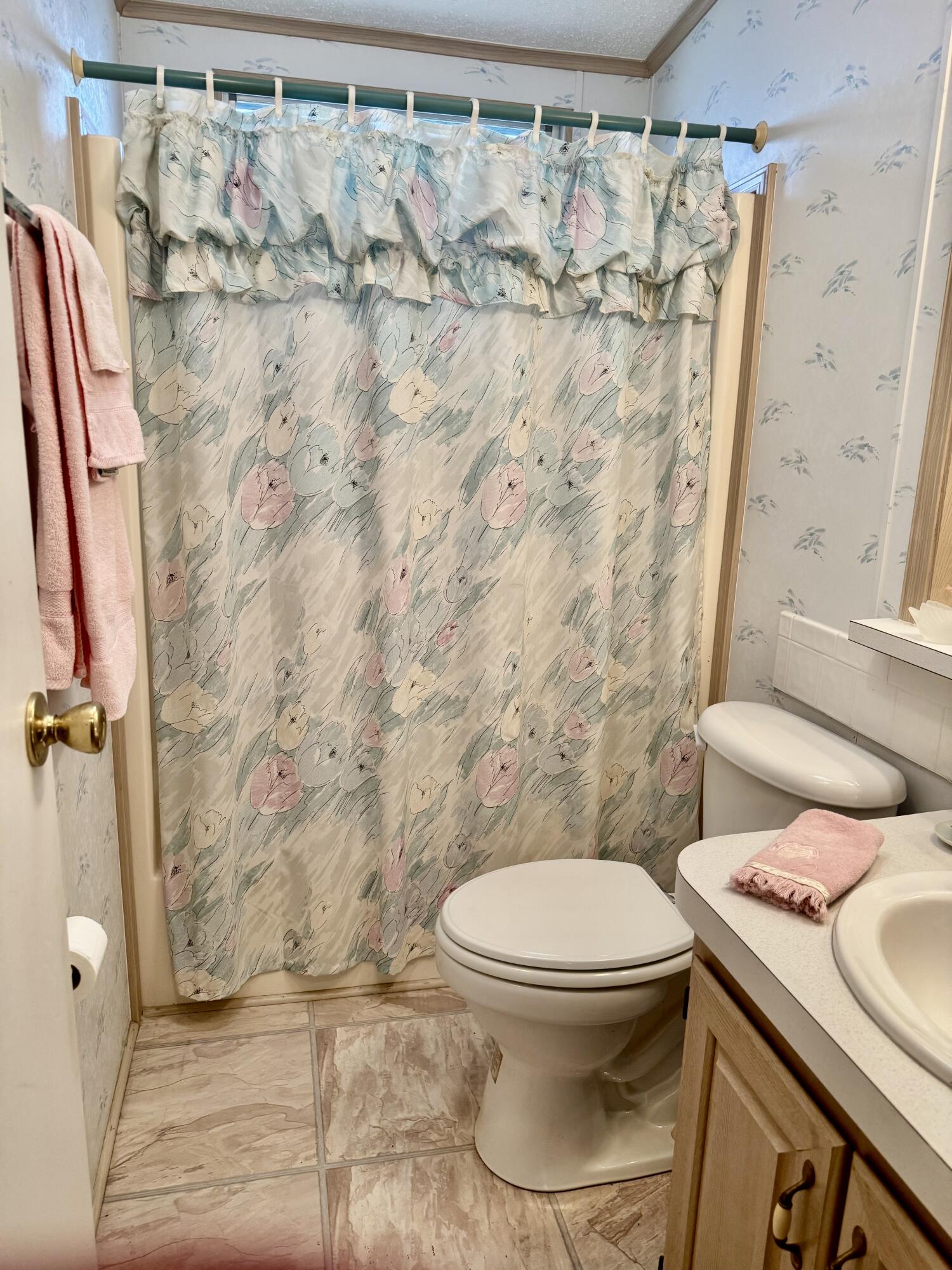 1704 Southwest 35th Circle Okeechobee, FL 34974 - Photo 9 of 44 a white toilet sitting next to a shower curtain