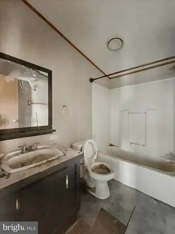 a bathroom with a sink vanity mirror and toilet