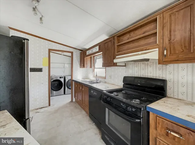 a kitchen with a stove and a refrigerator