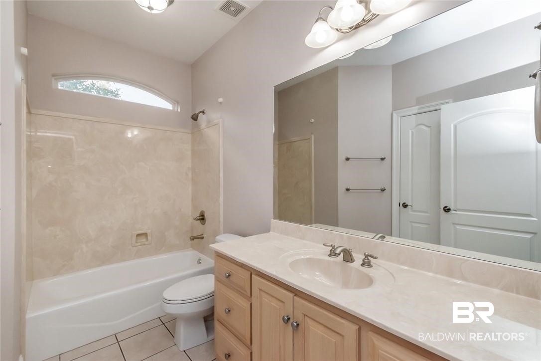 8837 Dawes Lake Road South Mobile, AL 36619 - Photo 29 of 44 Full bathroom featuring tile patterned floors, vanity, toilet, and tub / shower combination