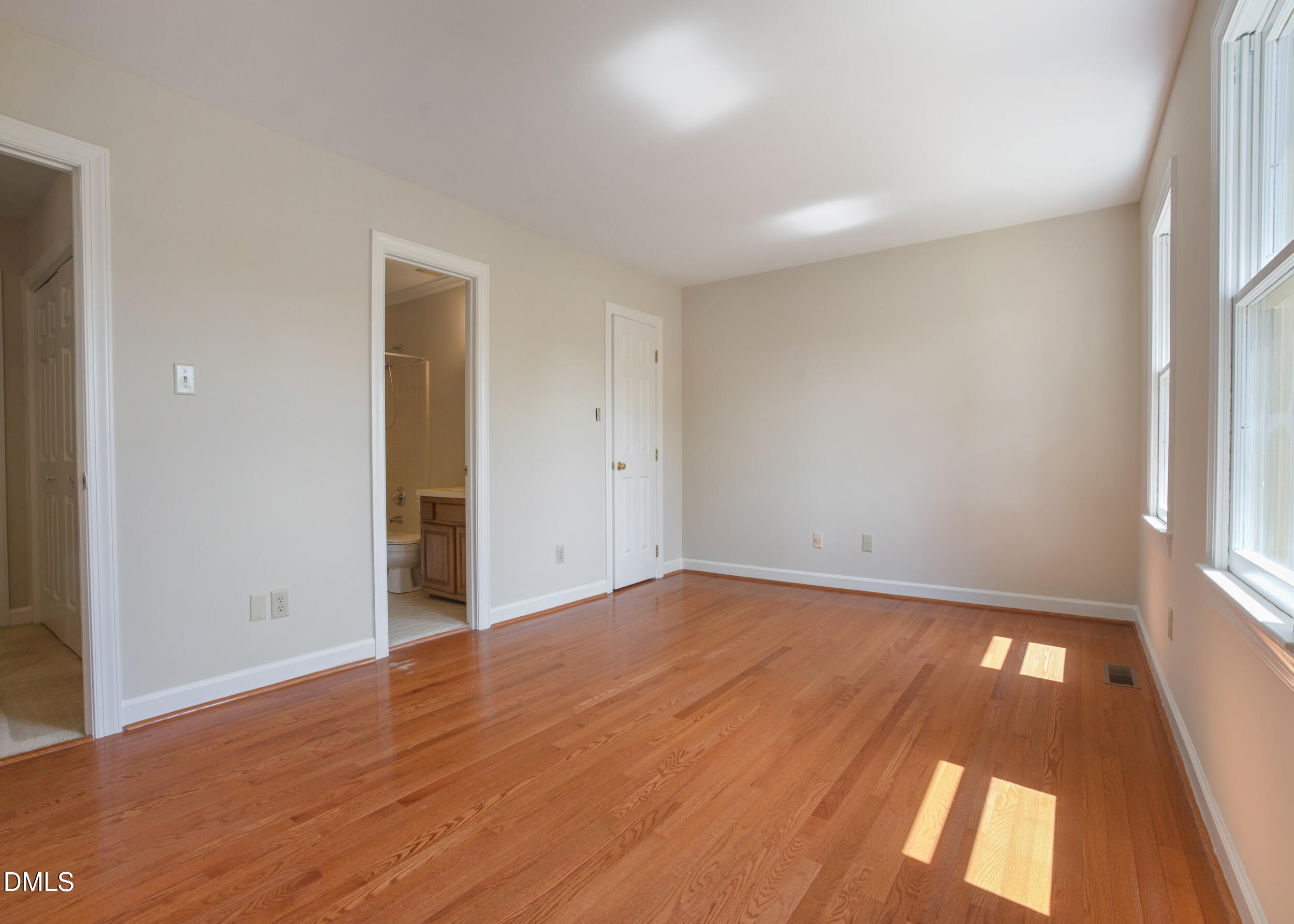 5018 Dunwoody Trail Raleigh, NC 27606 - Photo 13 of 24 wooden floor in an empty room with a window