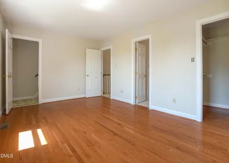 a view of an empty room and wooden floor