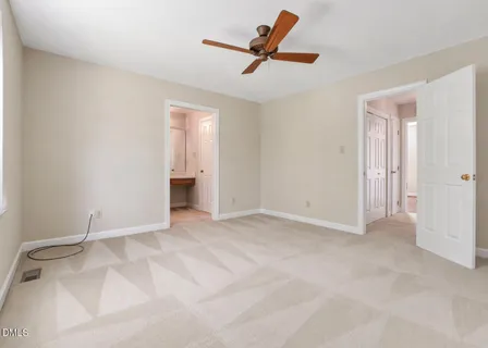 a view of room with ceiling fan and window